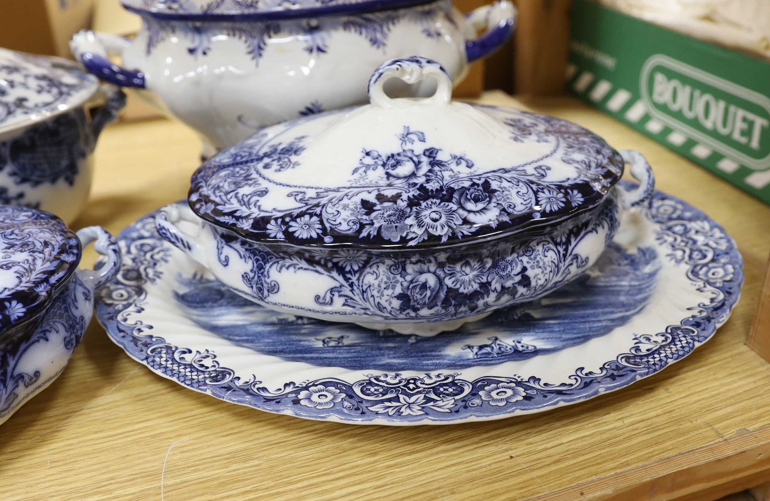 Two blue and white soup tureens and two vegetable tureens and a meat dish